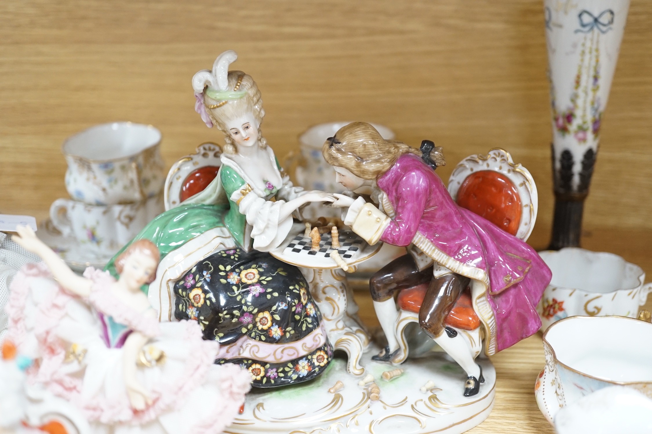 A group of Continental porcelain cabinet cups and saucers, a vase, crinoline figures and a Meissen horse, horse 9 cms high